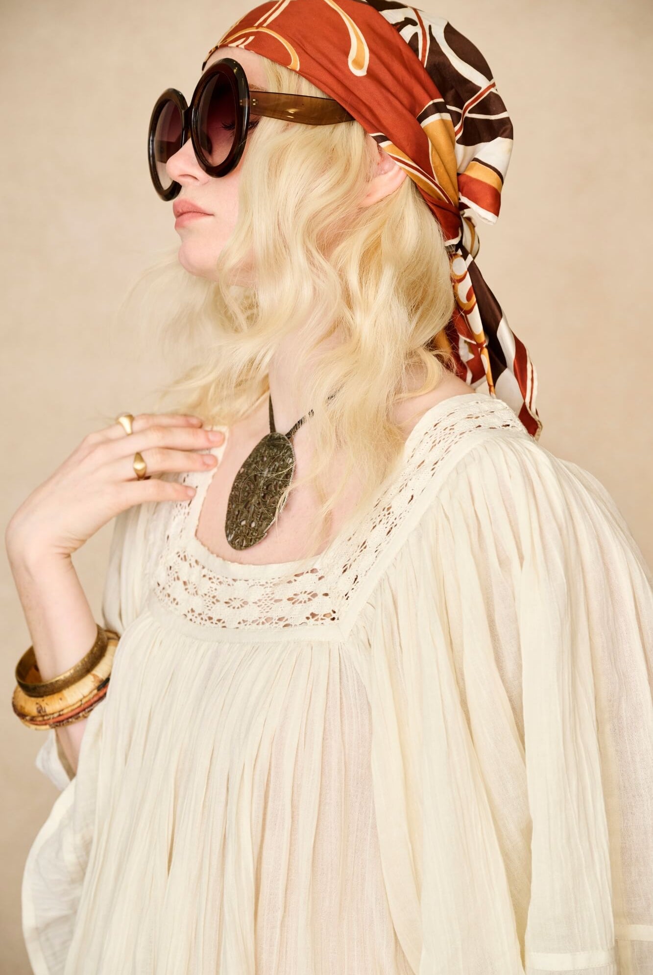 Model wearing 70s cream mini dress with lace-up Penny Lane boots by The Hippie Shake, close up view