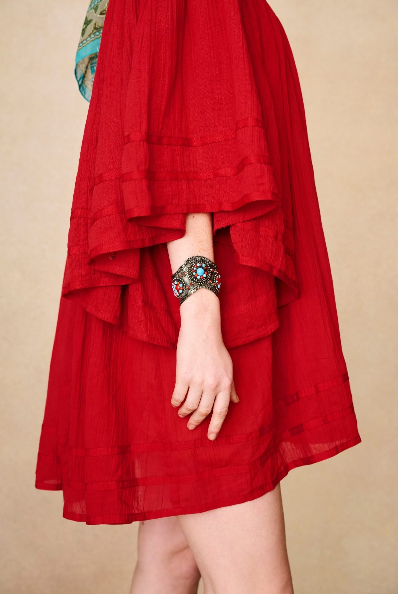 Model wearing 70s red mini dress with lace-up Penny Lane boots by The Hippie Shake, side view