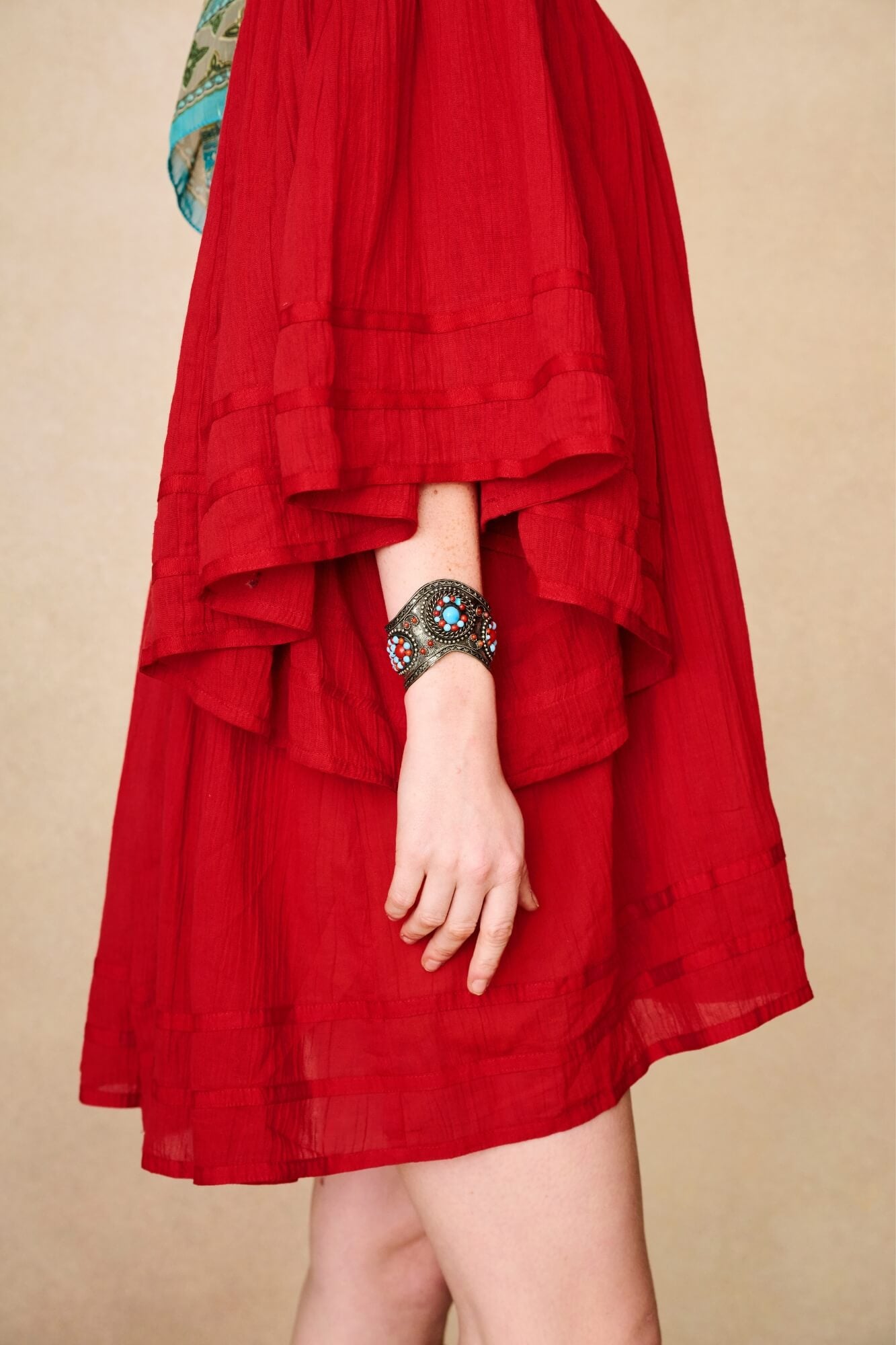 Model wearing 70s red mini dress with lace-up Penny Lane boots by The Hippie Shake, side view