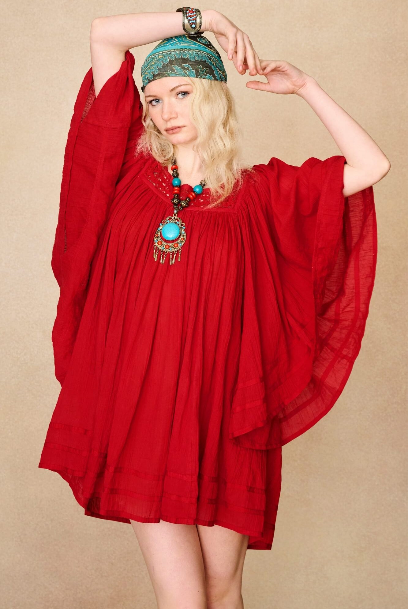 Model wearing 70s red mini dress with lace-up Penny Lane boots by The Hippie Shake, front view