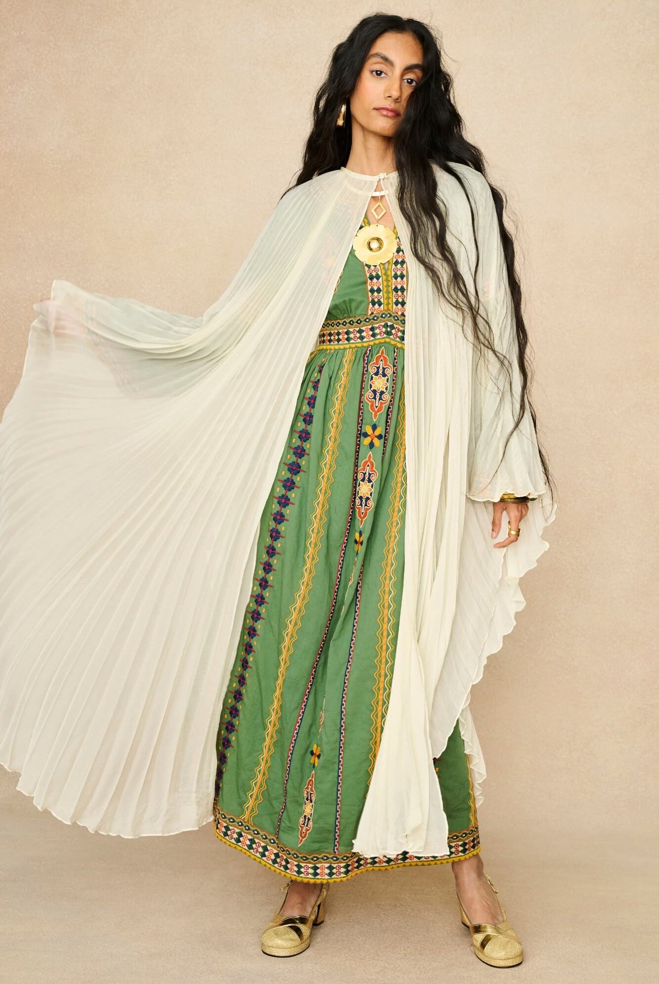 Model wearing 70s cream cape by The Hippie Shake, front view
