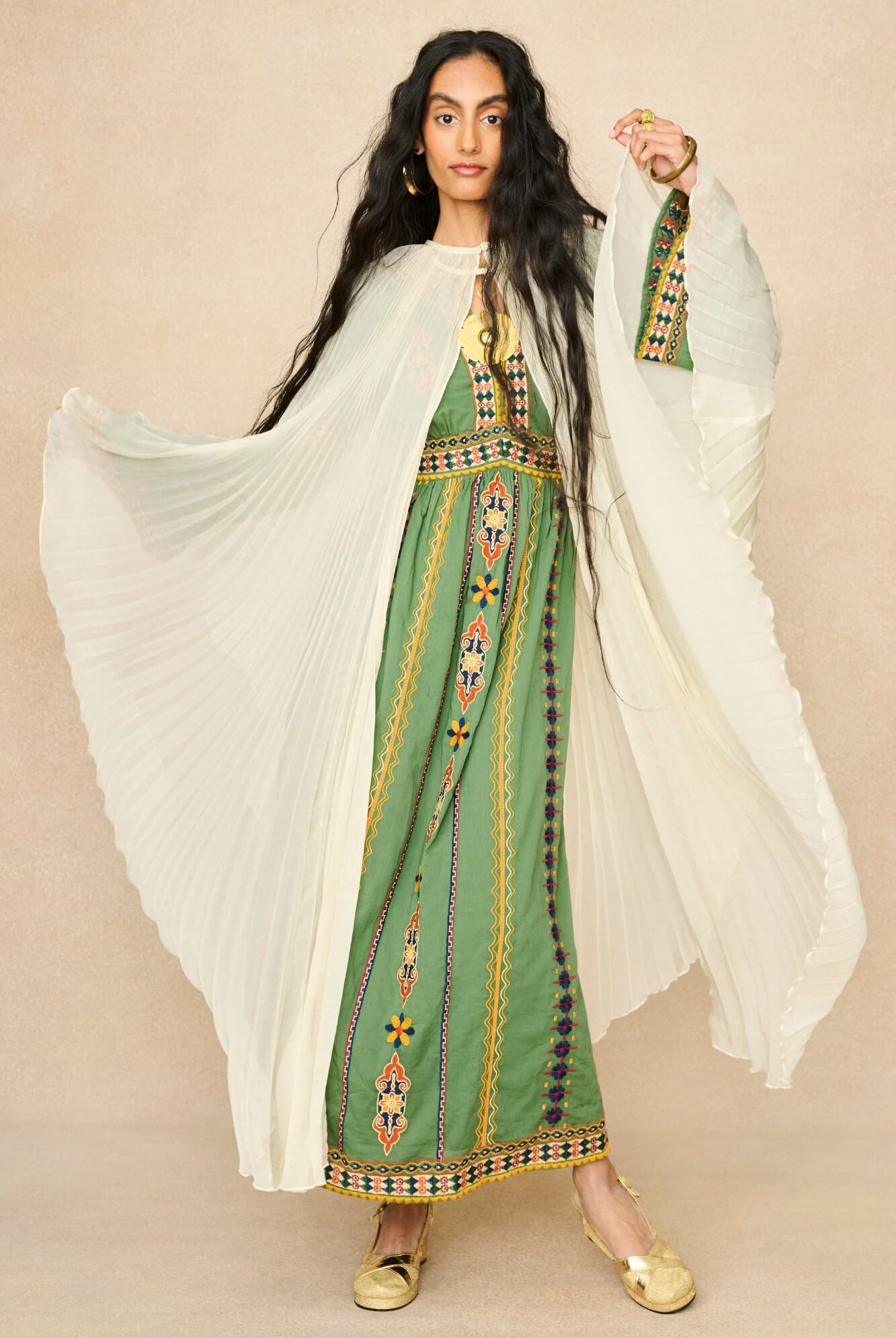 Model wearing 70s cream cape by The Hippie Shake, front view