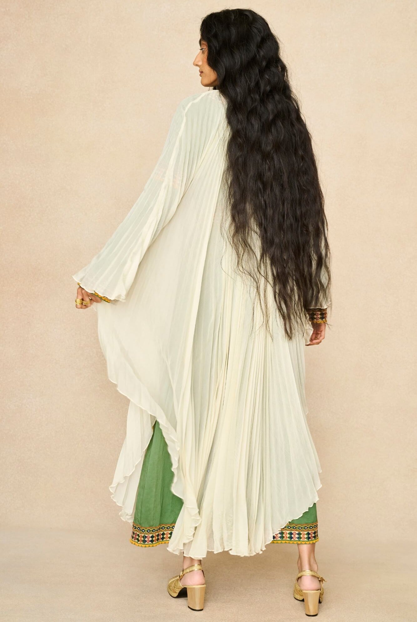 Model wearing 70s cream cape by The Hippie Shake, back view