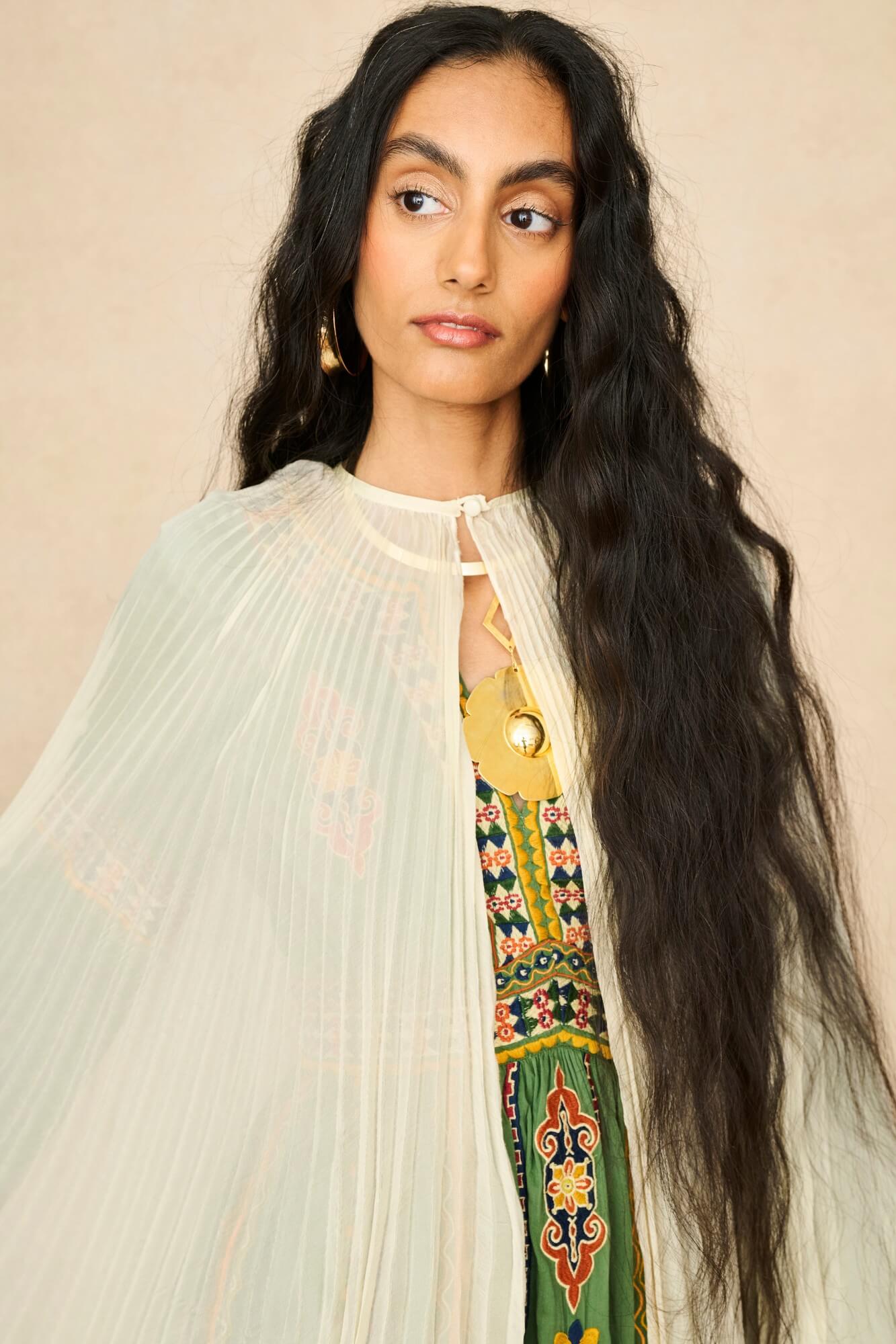 Model wearing 70s cream cape by The Hippie Shake, close up