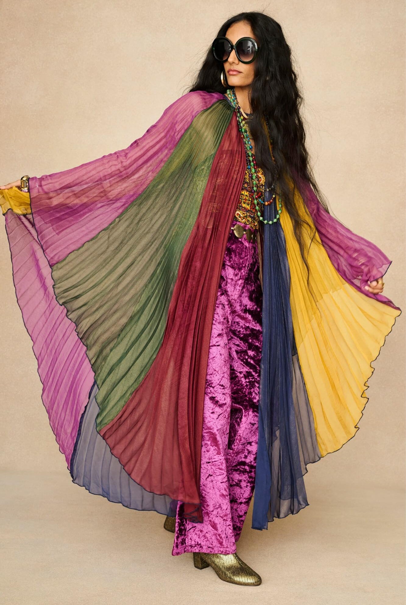 Model wearing rainbow striped cape by The Hippie Shake, front view
