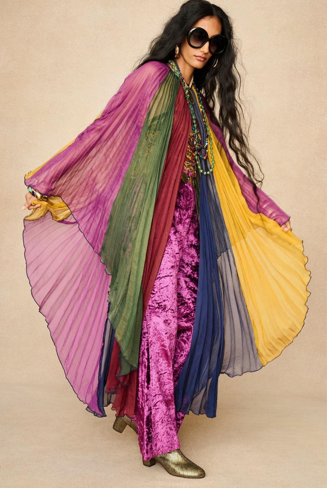Model wearing rainbow striped cape by The Hippie Shake, front view