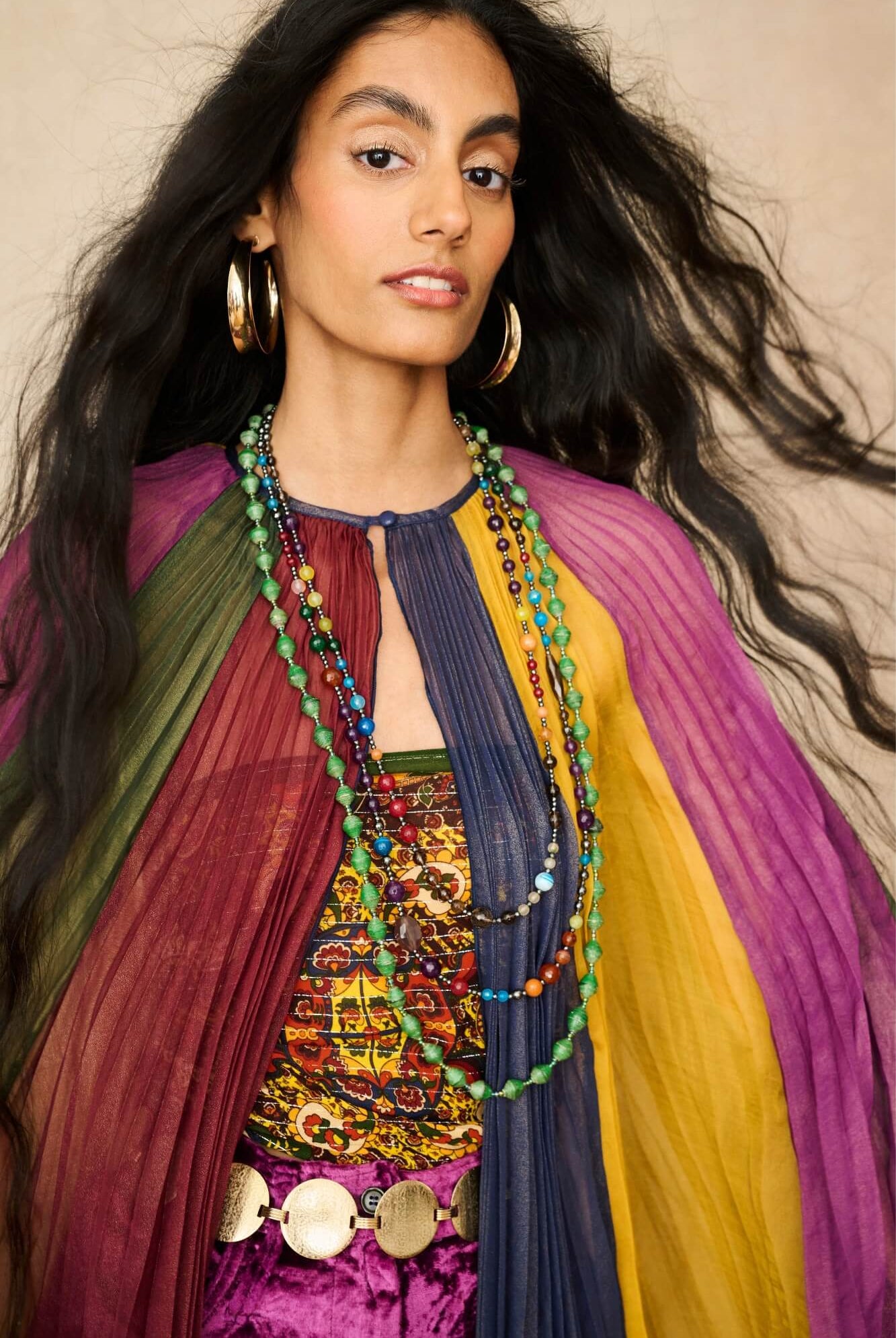 Model wearing rainbow striped cape by The Hippie Shake, close up