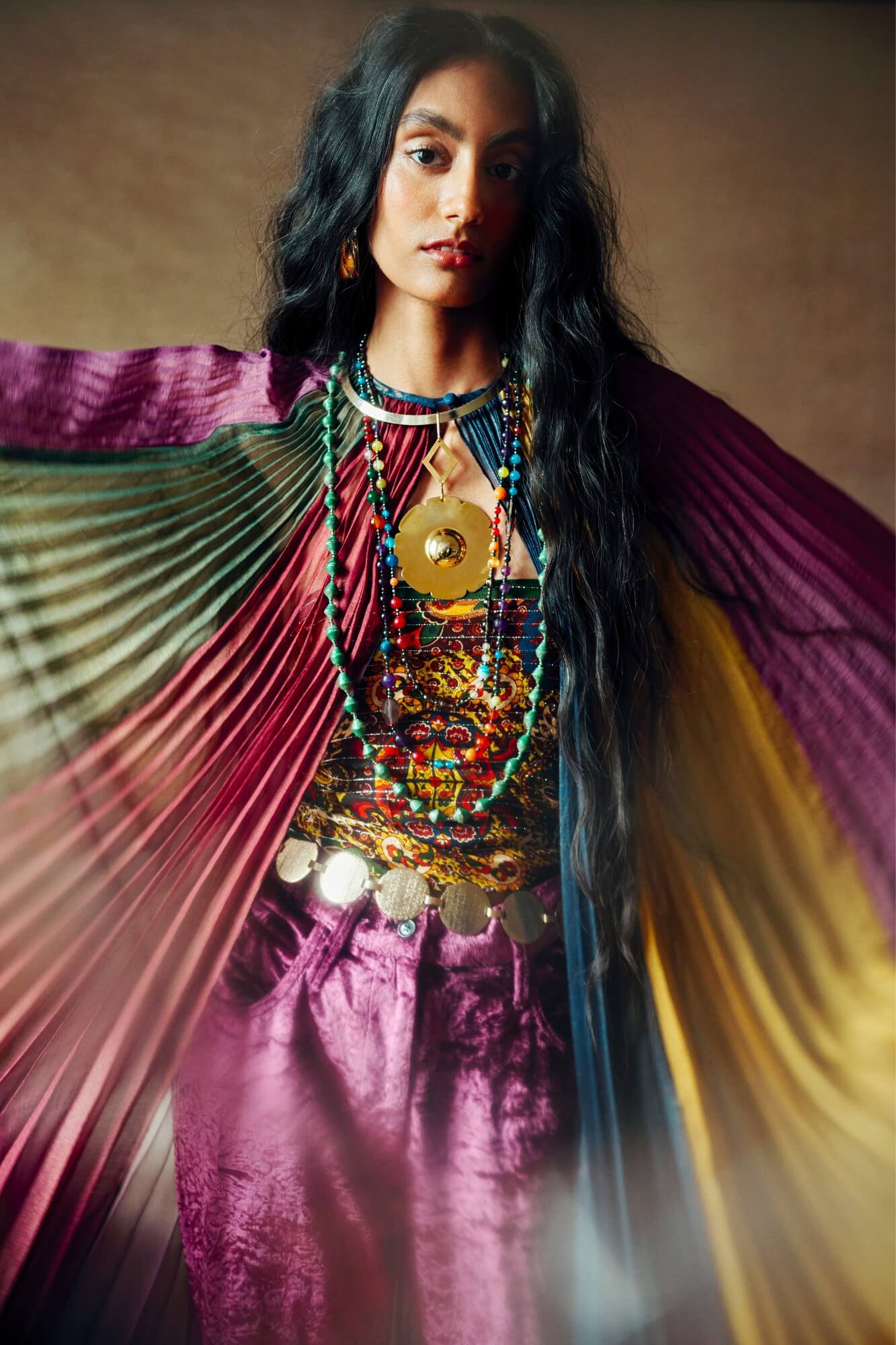 Model wearing rainbow striped cape by The Hippie Shake, front view
