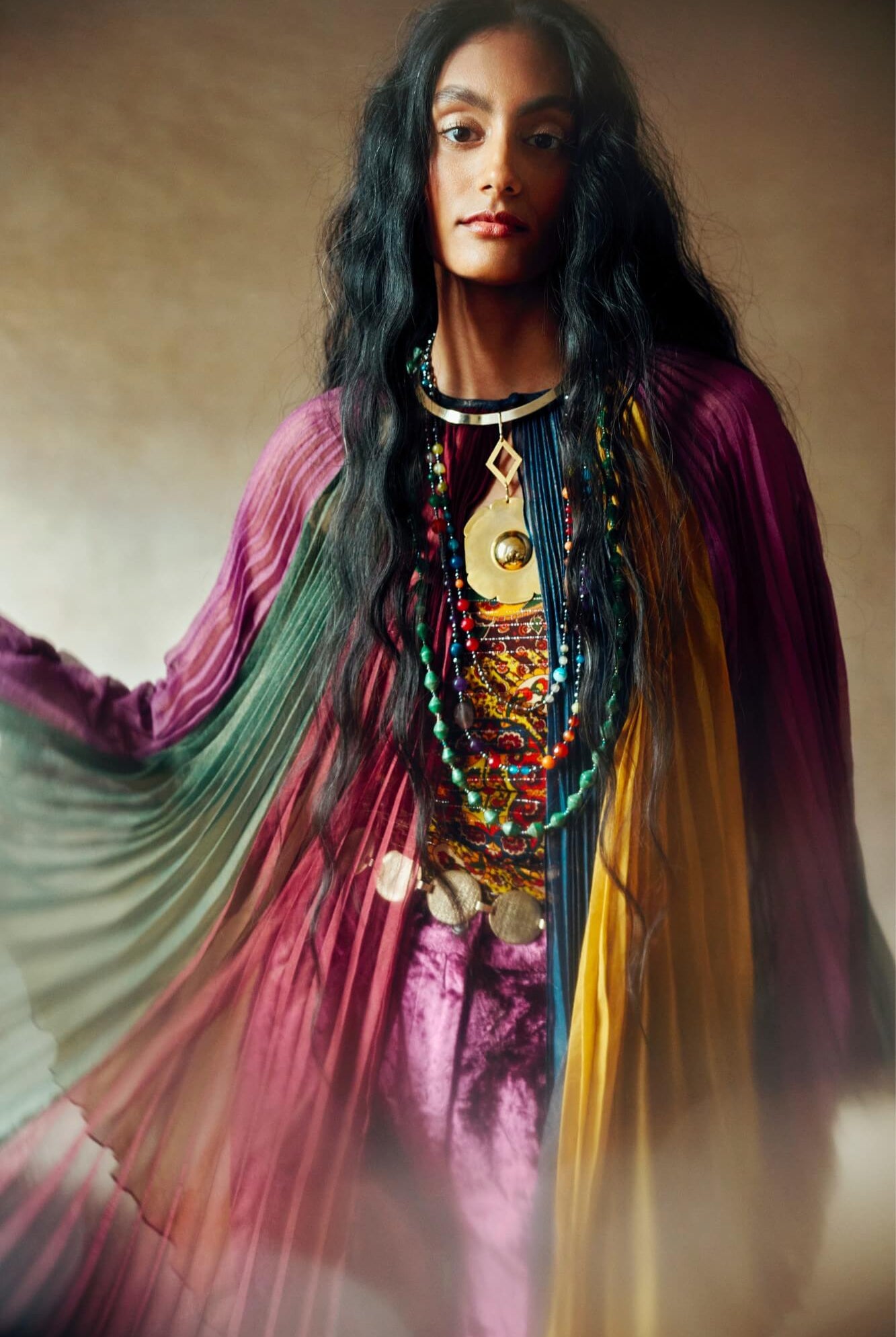 Model wearing rainbow striped cape by The Hippie Shake, front view
