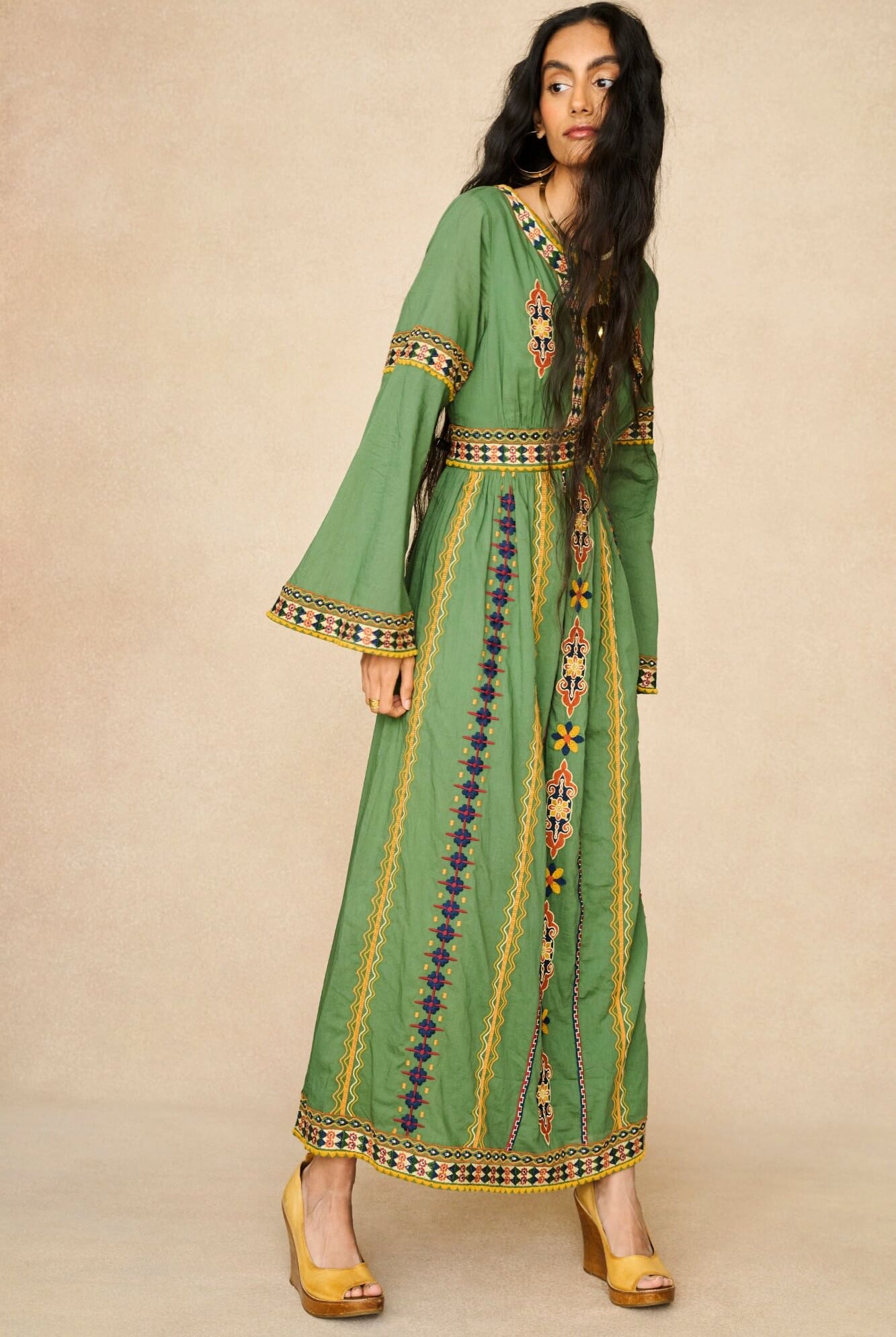 Model wearing 70s green embroidered maxi dress by The Hippie Shake, front view
