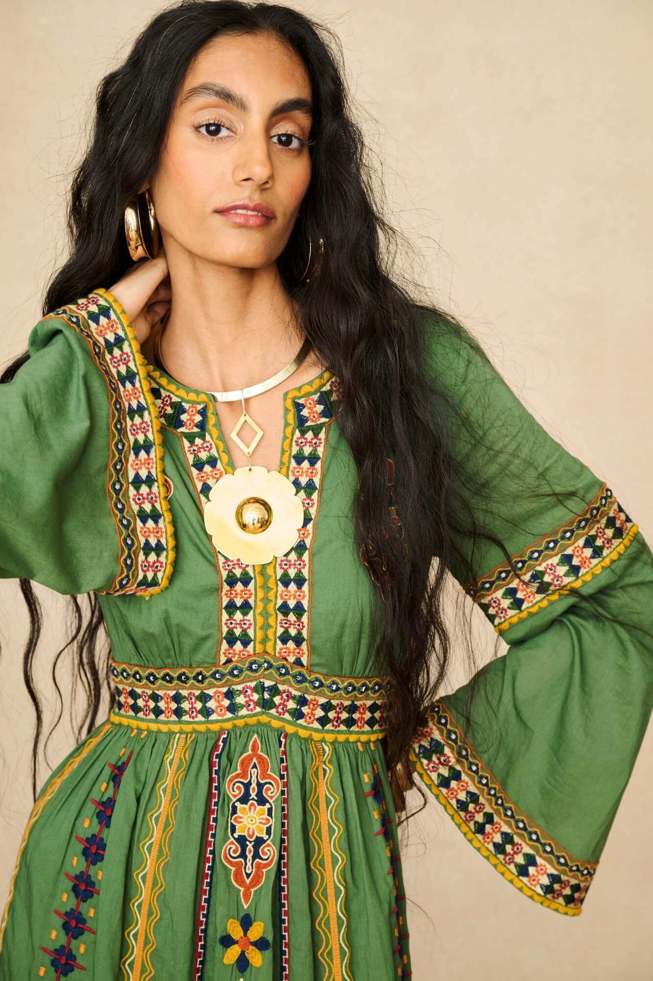 Model wearing 70s green embroidered maxi dress by The Hippie Shake, close up