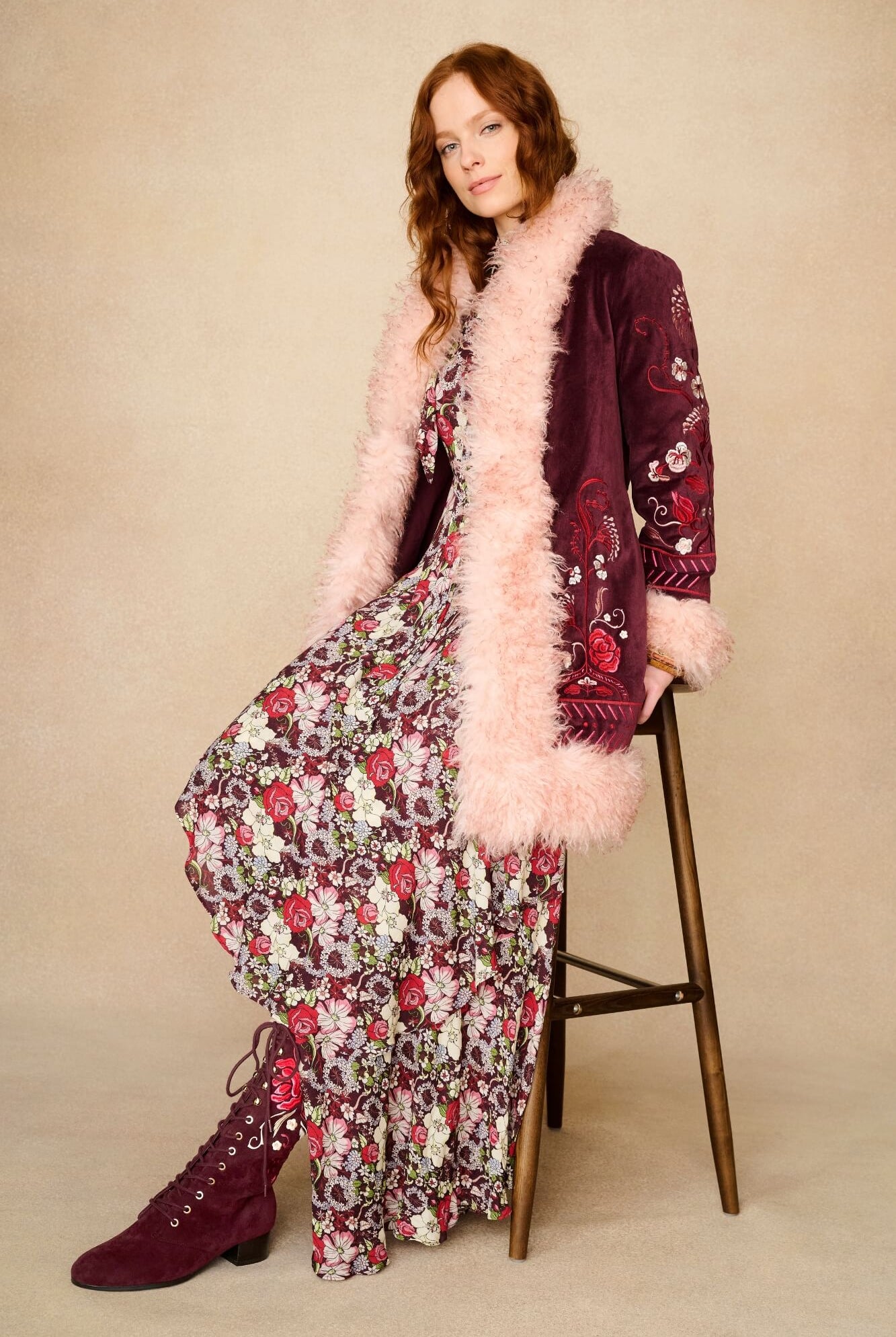 Model wearing burgundy lace-up Penny Lane boots with penny lane coat from Pamela Des Barres collection by The Hippie Shake, side view