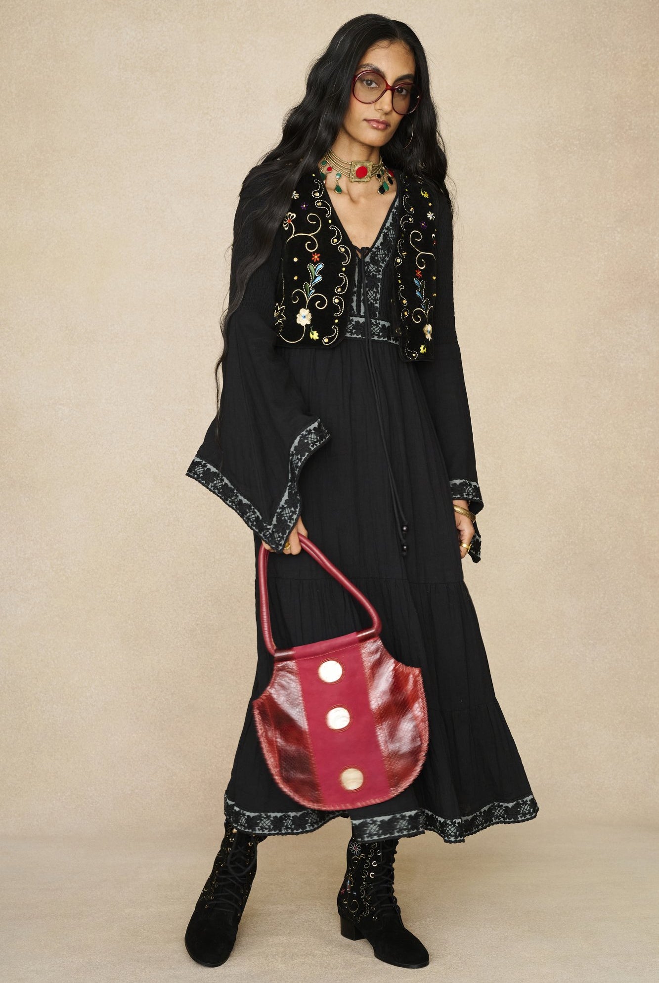 Model wearing 70s black long sleeve maxi dress with lace-up Penny Lane boots by The Hippie Shake, front view