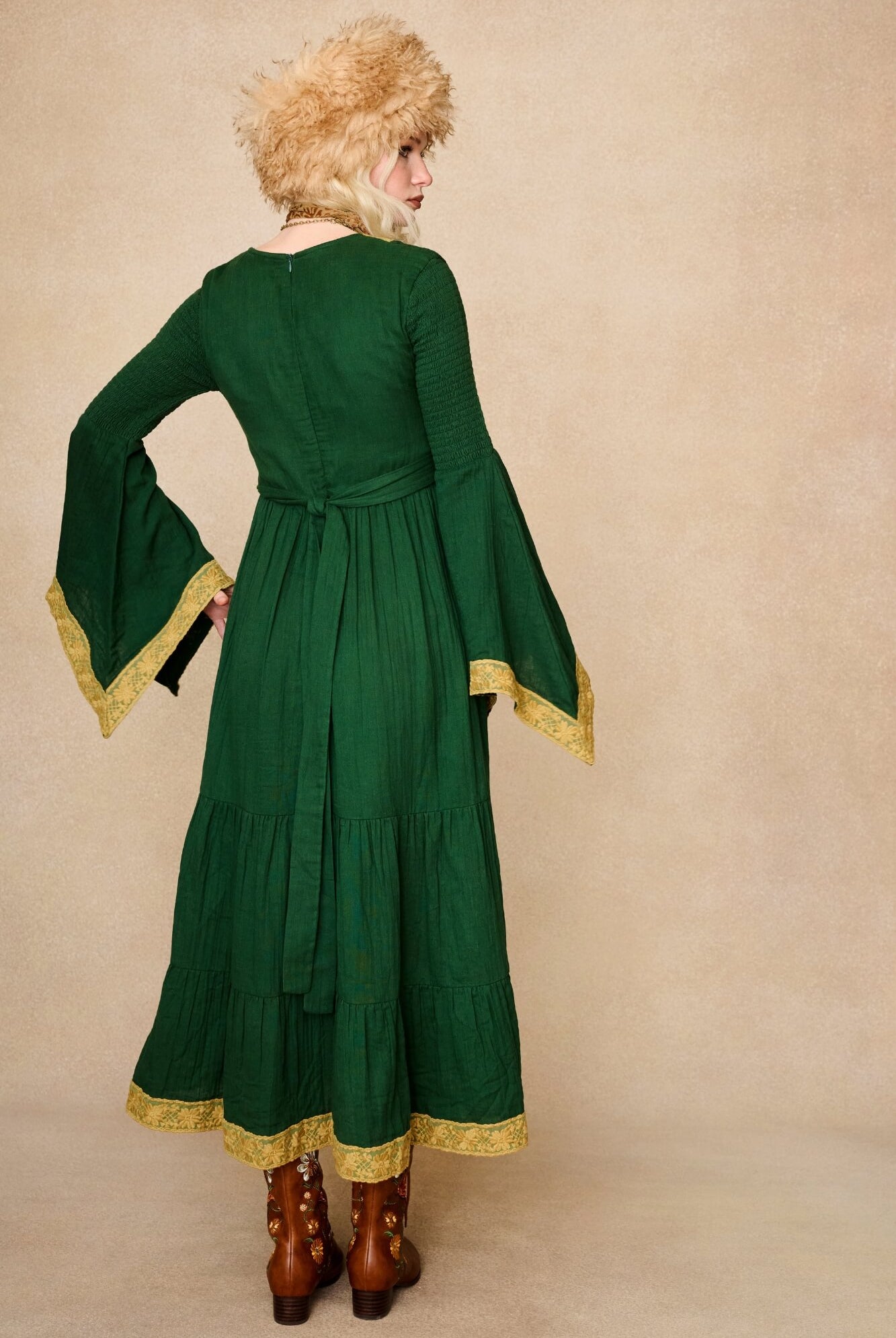 Model wearing 70s green long sleeve maxi dress with lace-up Penny Lane boots by The Hippie Shake, back view