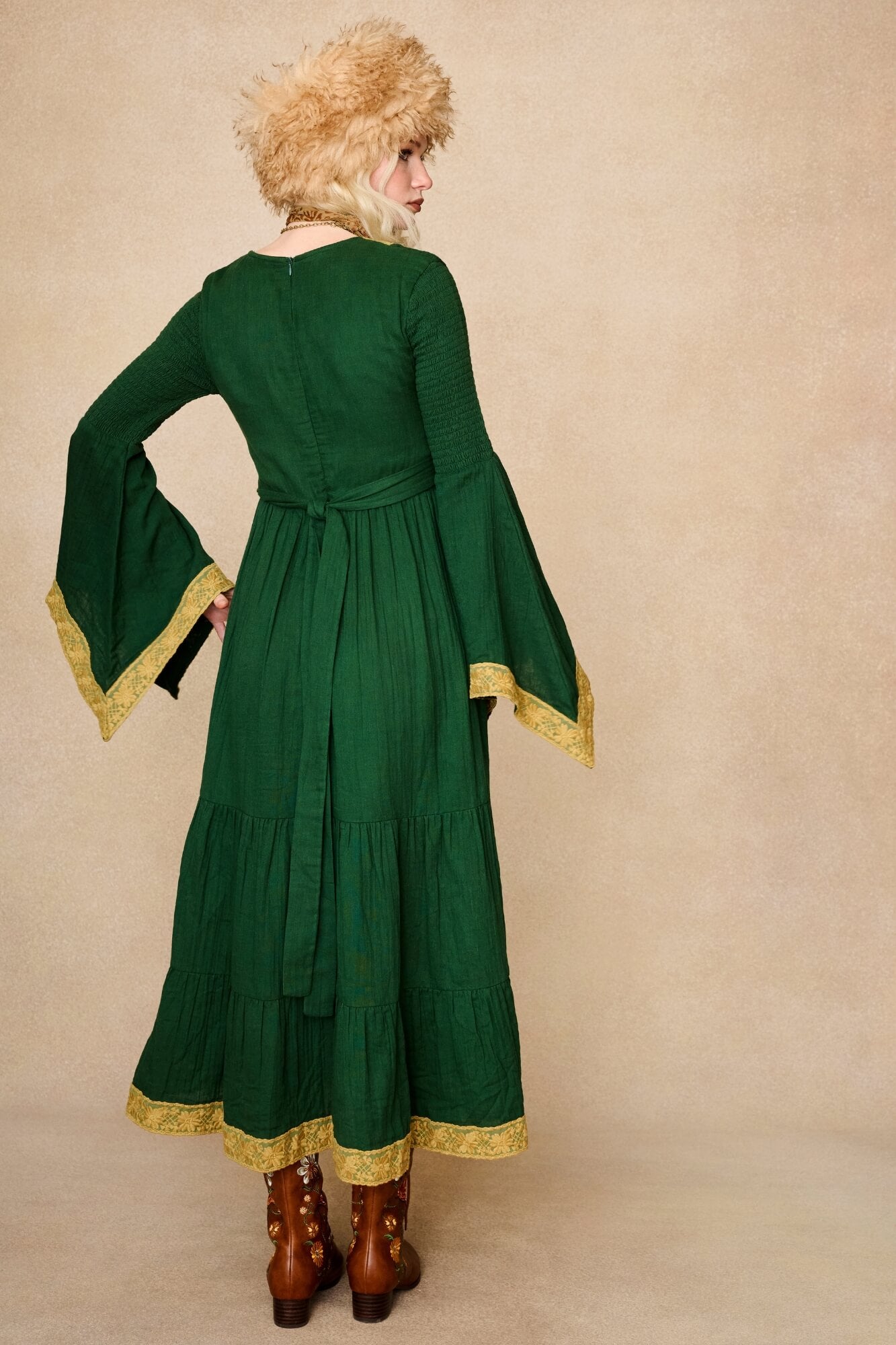 Model wearing 70s green long sleeve maxi dress with lace-up Penny Lane boots by The Hippie Shake, back view