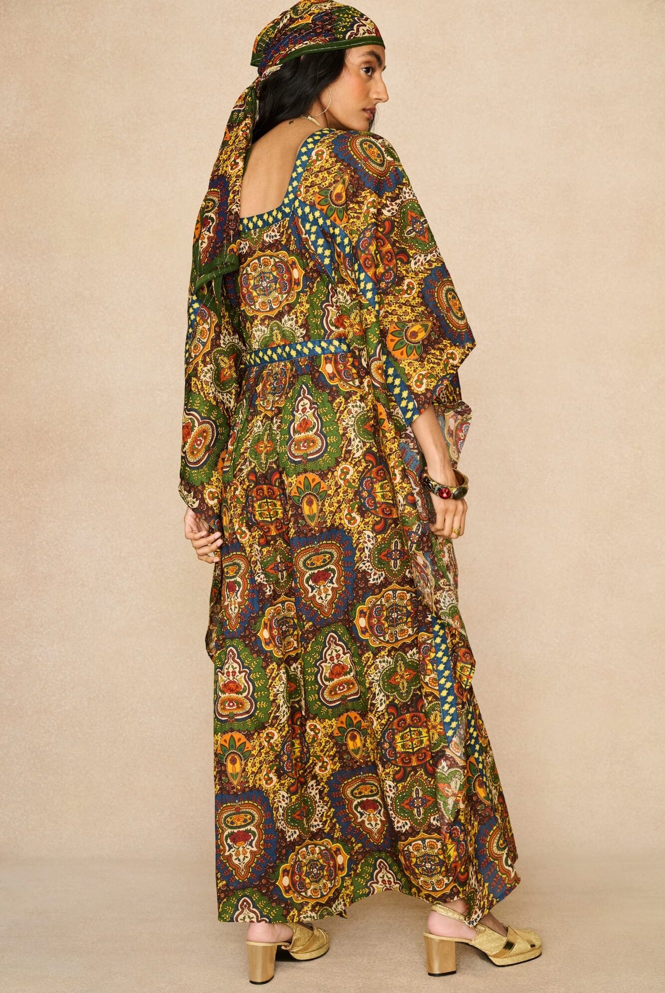 Model wearing 70s printed kaftan by The Hippie Shake, back view