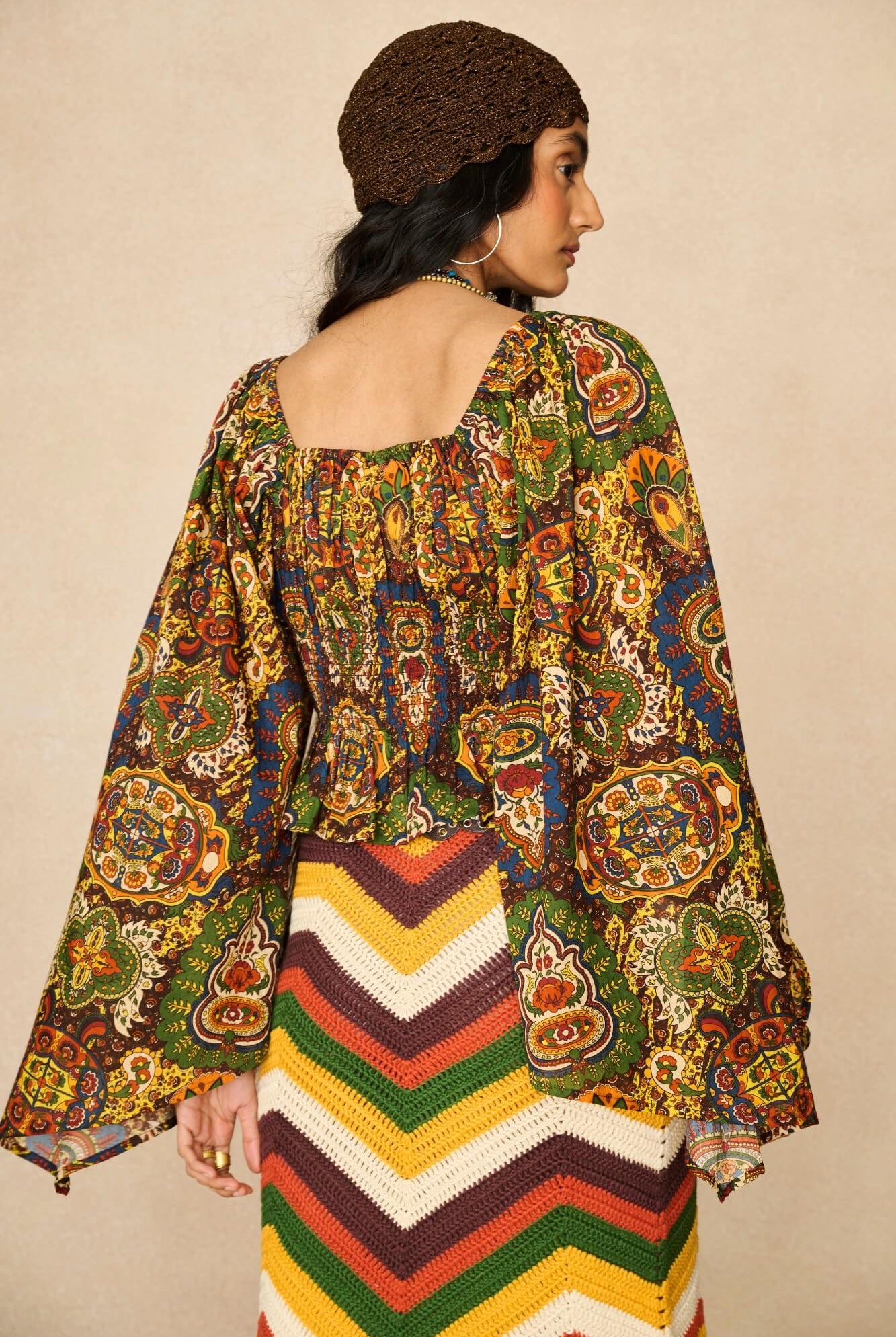 Model wearing 70s printed long sleeve top by The Hippie Shake, back view