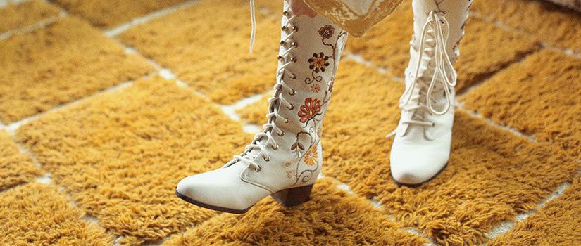 Hero banner for women's boho and 70s inspired boots and shoes from The Hippie Shake - Close up of cream embroidered Penny Lane boots.