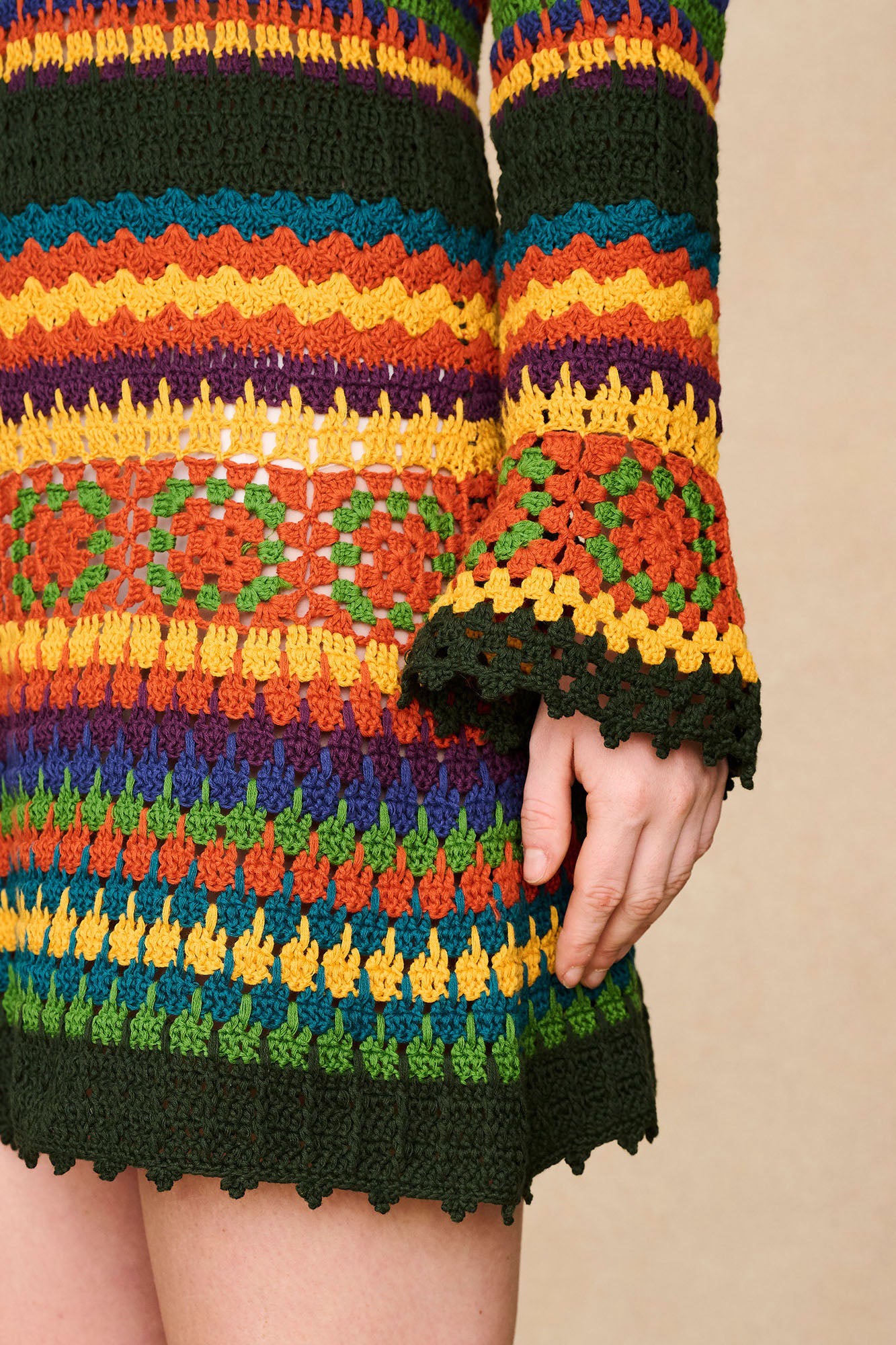 Close-up of The Hippie Shake's crochet dream mini dress, showcasing the intricate detailing and flared sleeves.