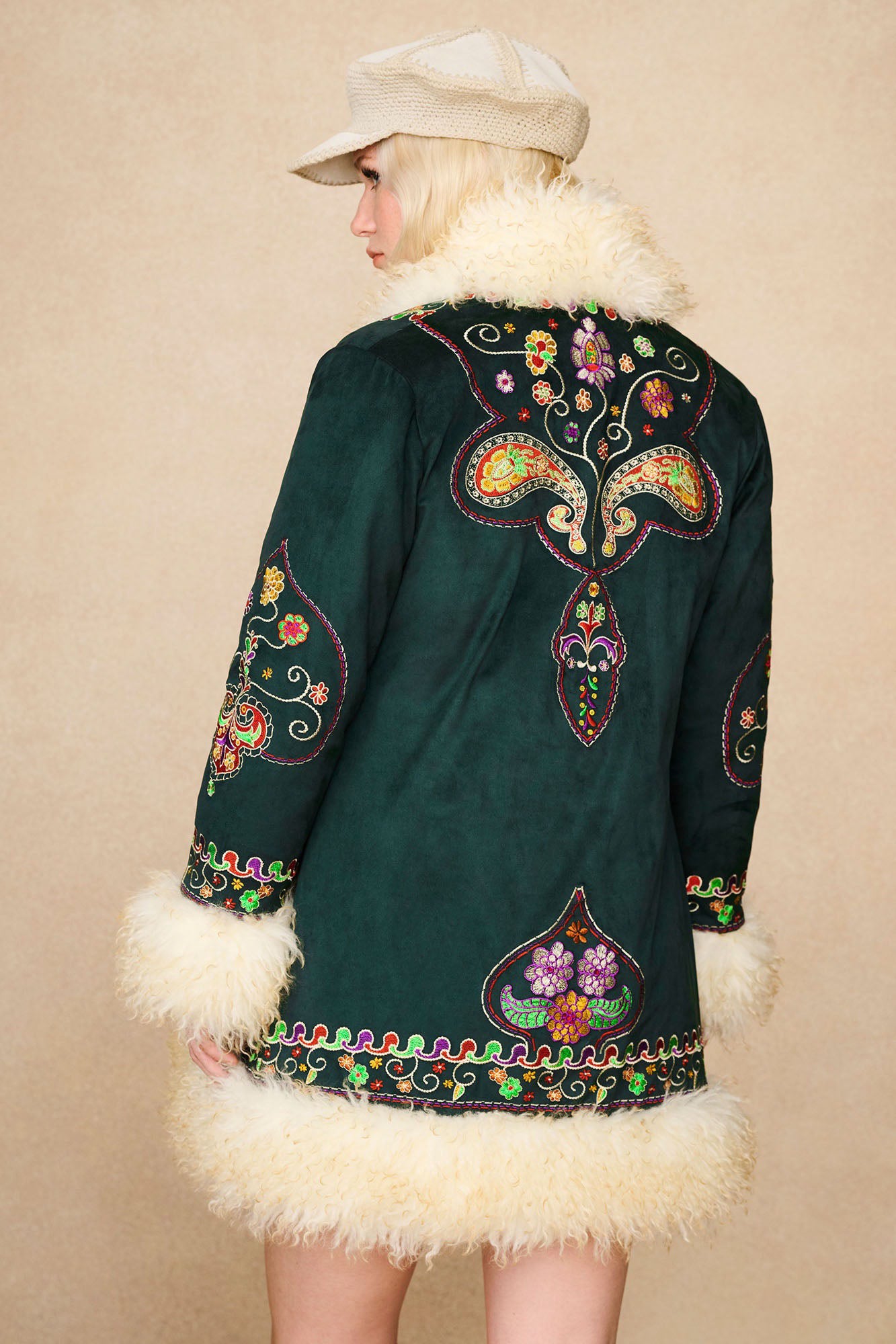 Back view of The Hippie Shake's green afghan coat highlighting symmetrical floral embroidery and faux shearling collar.