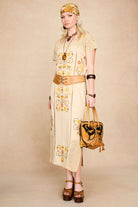 Full-length shot of The Hippie Shake's vintage style cream crochet trim midi dress styled with a statement belt.
