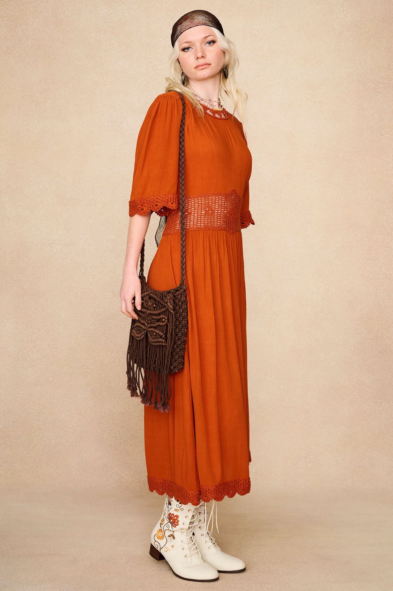 Model wearing The Hippie Shake's cream Penny Lane embroidered floral boots under a crochet embroidered midi dress.