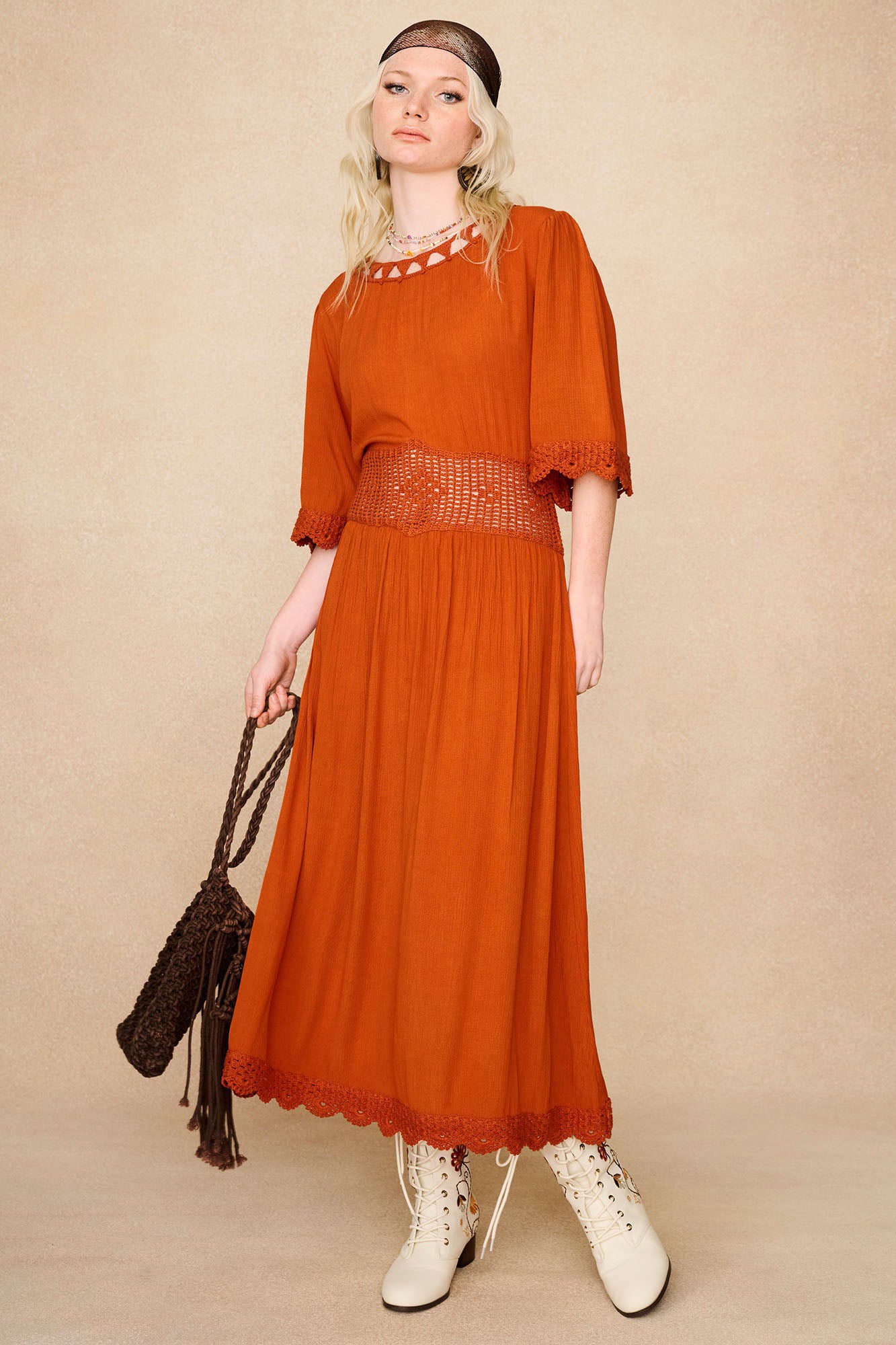 The Hippie Shake's vintage style crochet embroidered midi dress styled with white boots and brown accessories.
