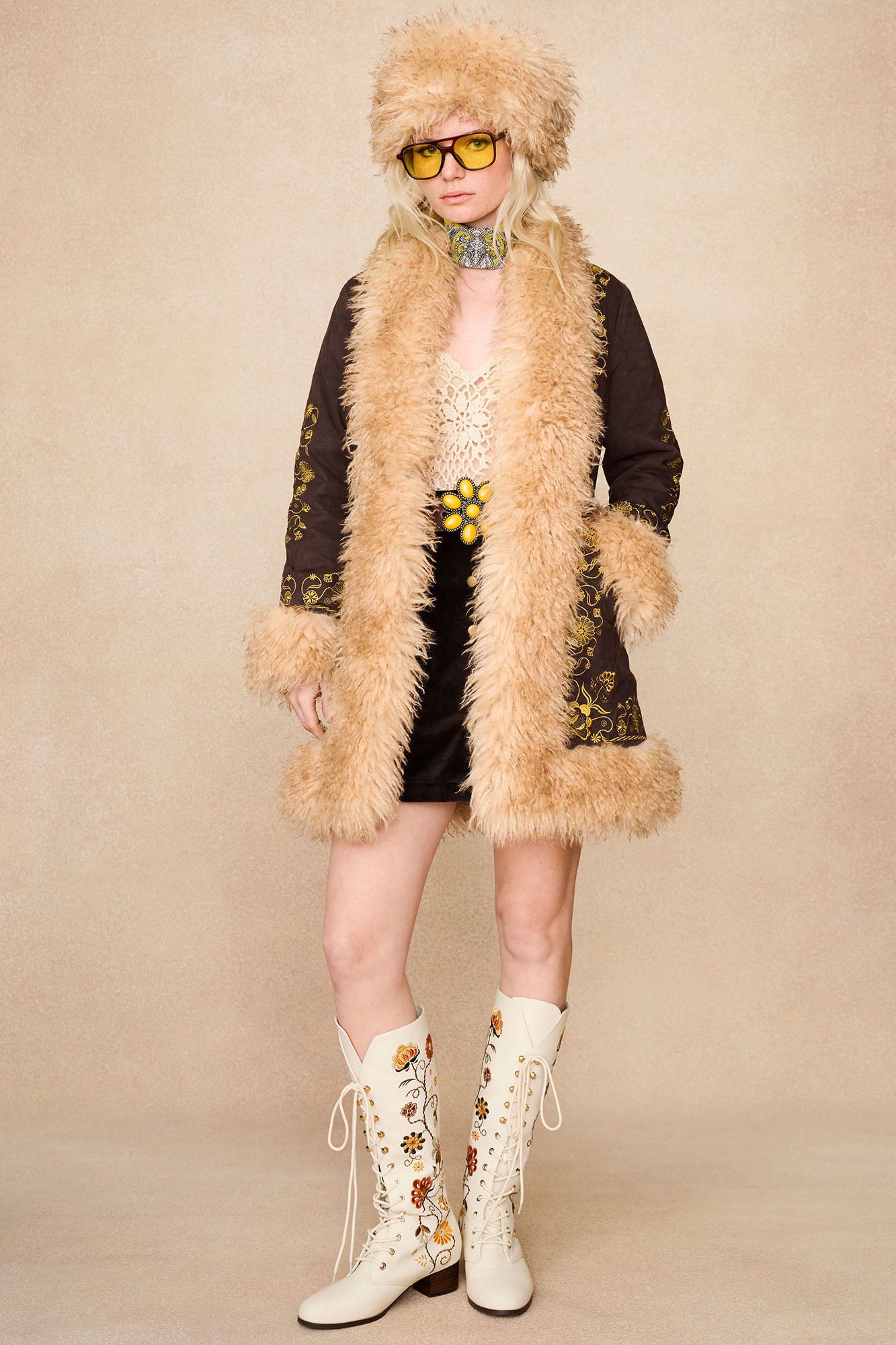 Full-length shot of model in The Hippie Shake's brown afghan coat styled with our cream crochet top and Penny Lane cream embroidered boots.