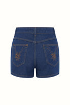 Flat lay of The Hippie Shake's women's high waisted denim shorts showing floral back pocket embroidery.