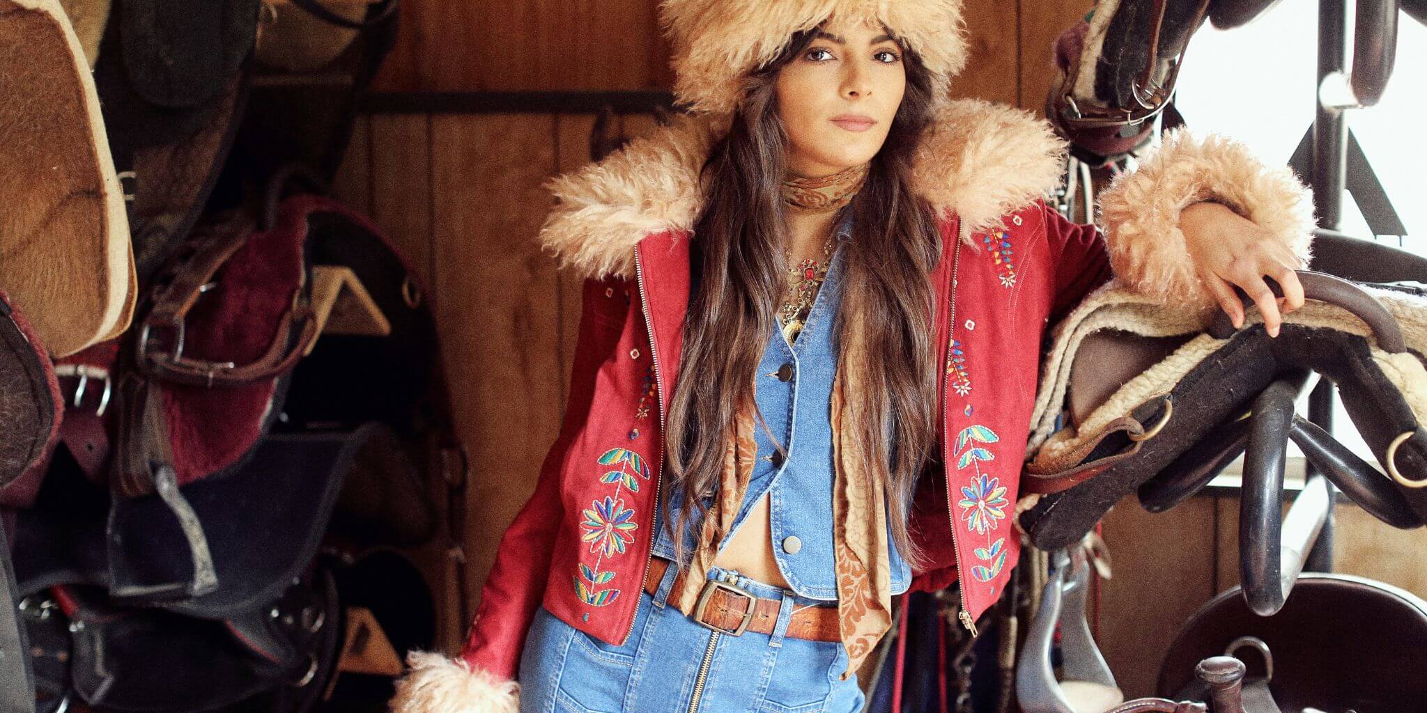 Model wears the Little Jeanis Wide leg Denim Jeans and Vest by The Hippie Shake paired with a red Penny lane coat and faux fur hat