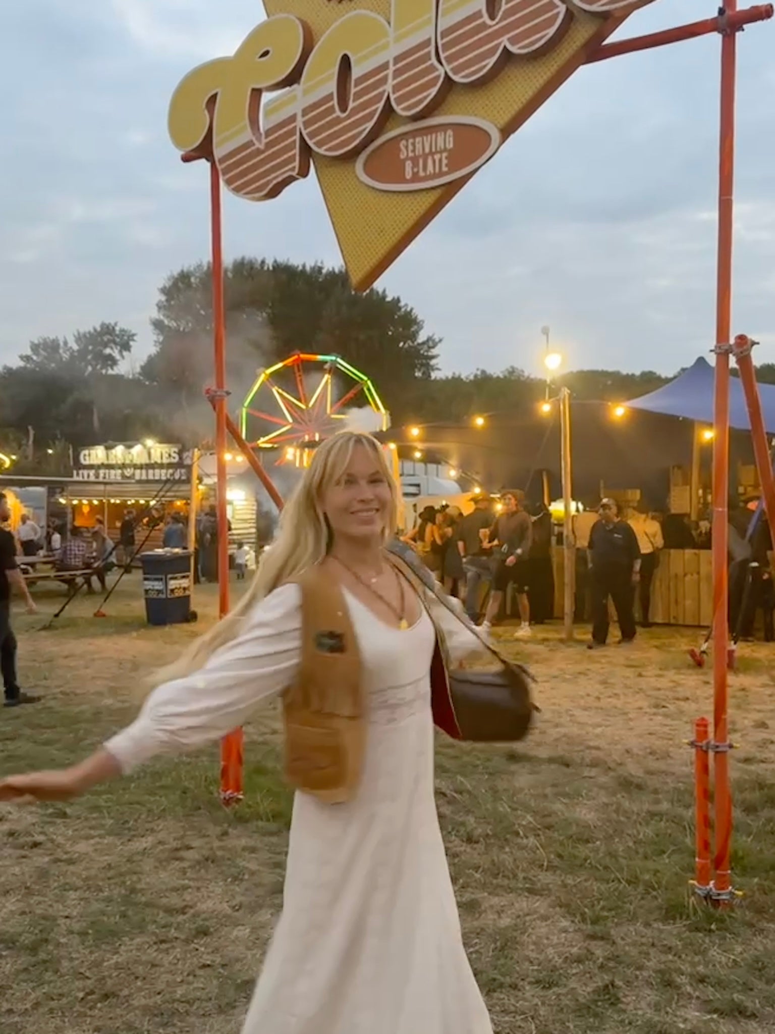 UGC image of @mayalaneuk wearing a long white The Hippie Shake maxi dress at a music festival
