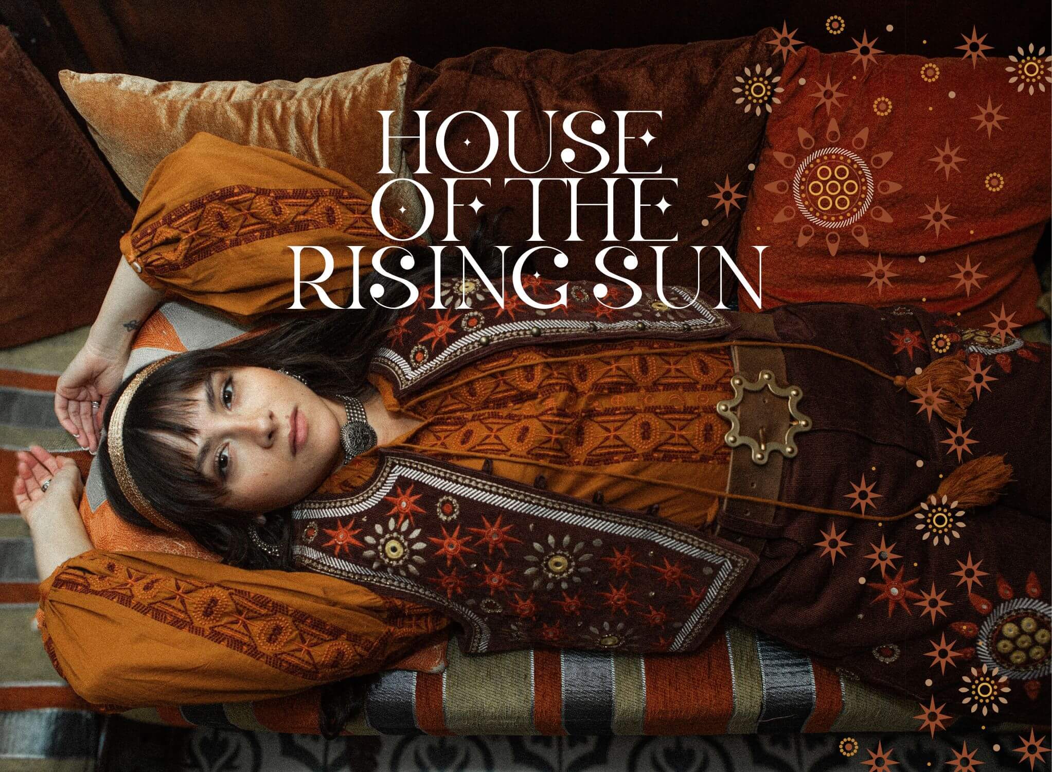 Model laying down 
wearing The Hippie Shake orange blouse and beaded 70s style vest from House Of The Rising Sun collection