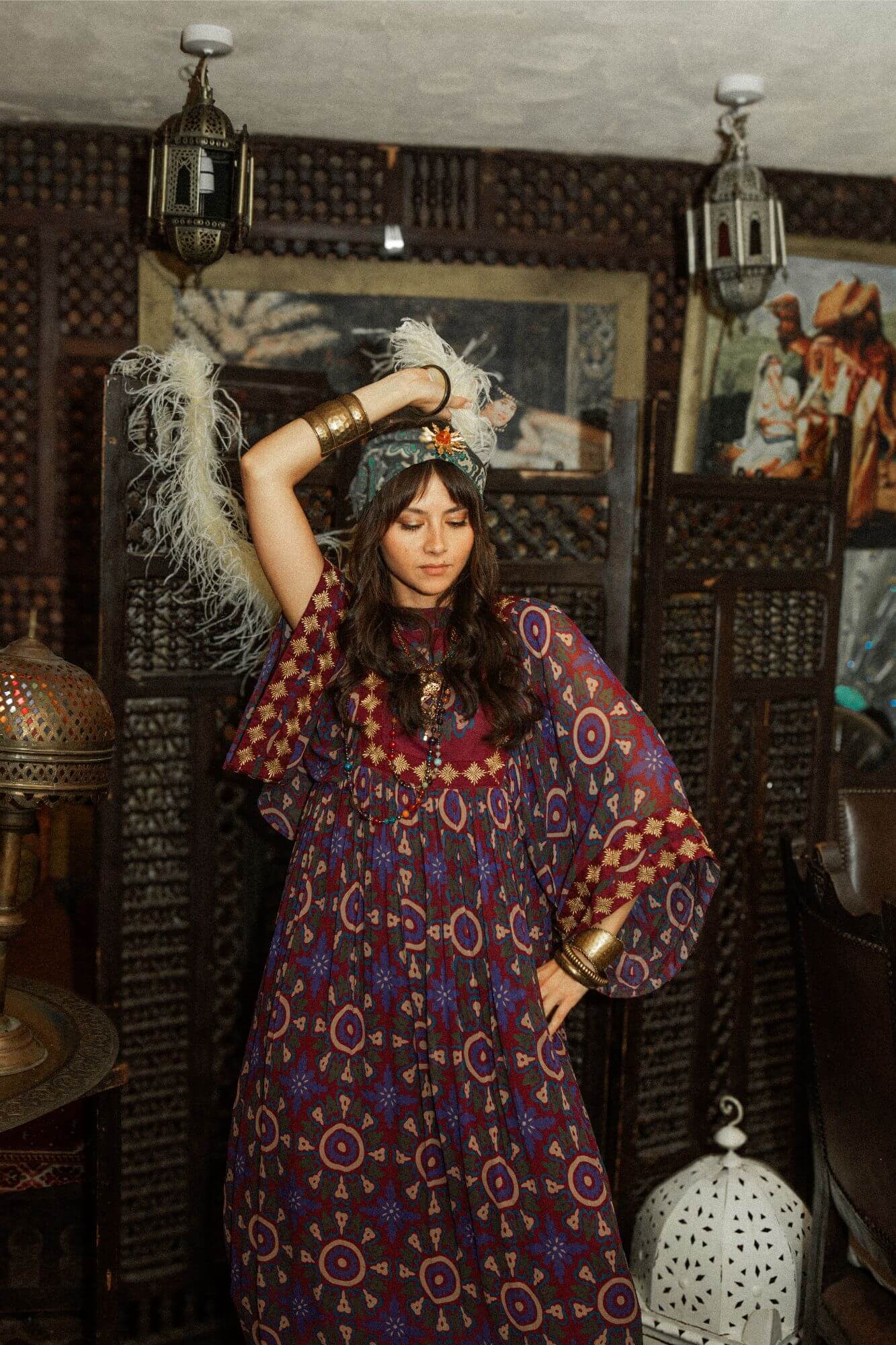 Model dancing wearing a 70s style bohemian maxi dress in a printed purple fabric with hand embroidery