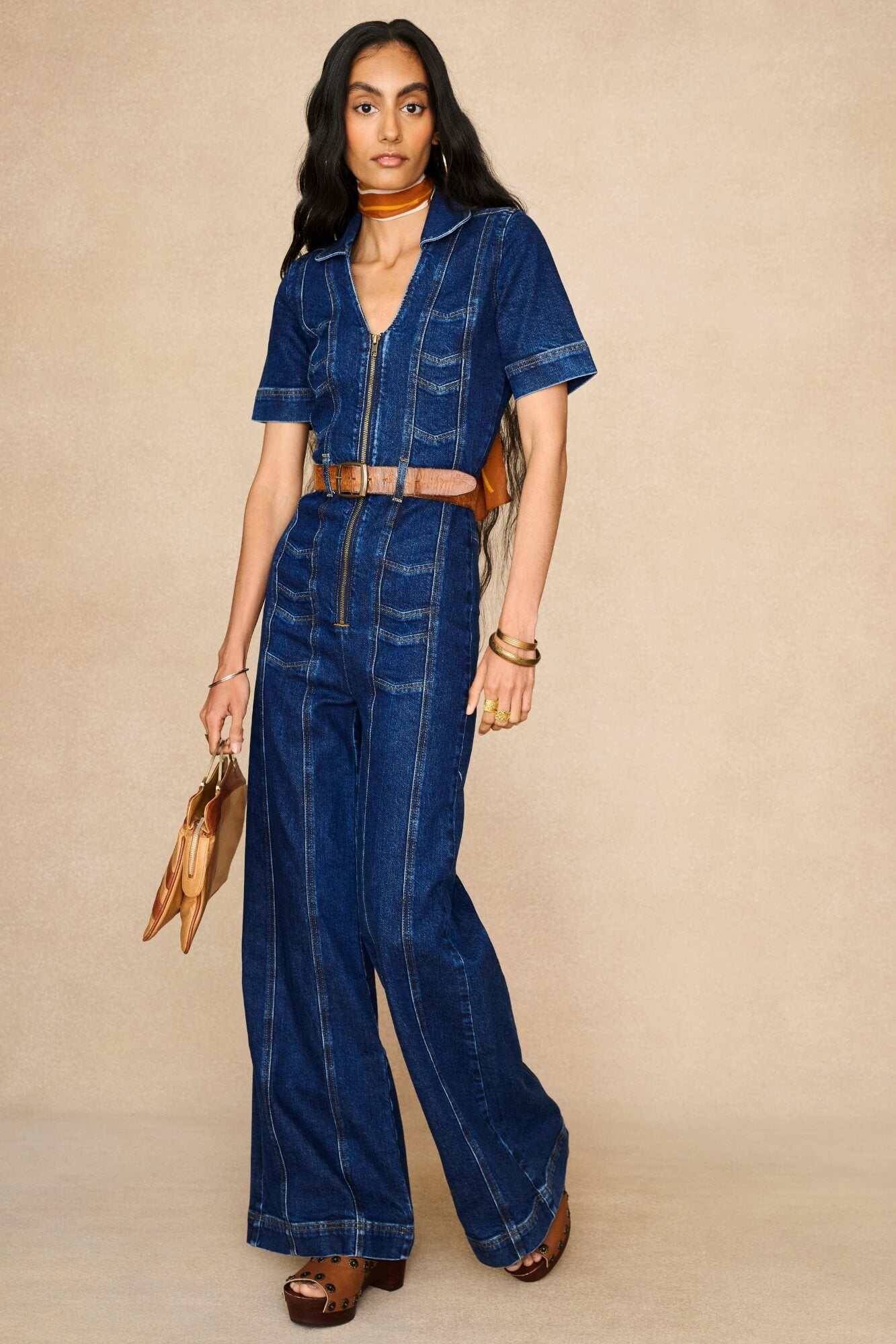 Model wearing 70s style denim jumpsuit by The Hippie Shake - front view