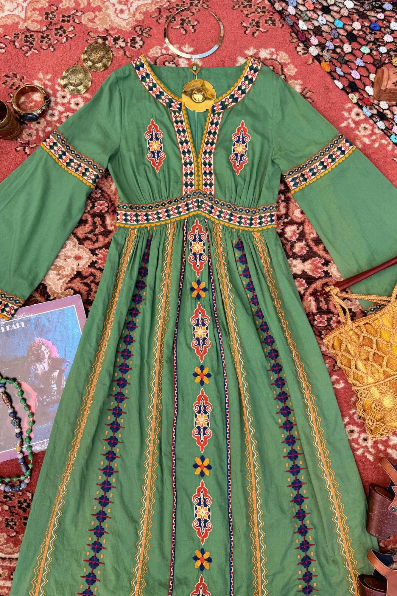 Flat lay of green 70s style embroidered dress by The Hippie Shake