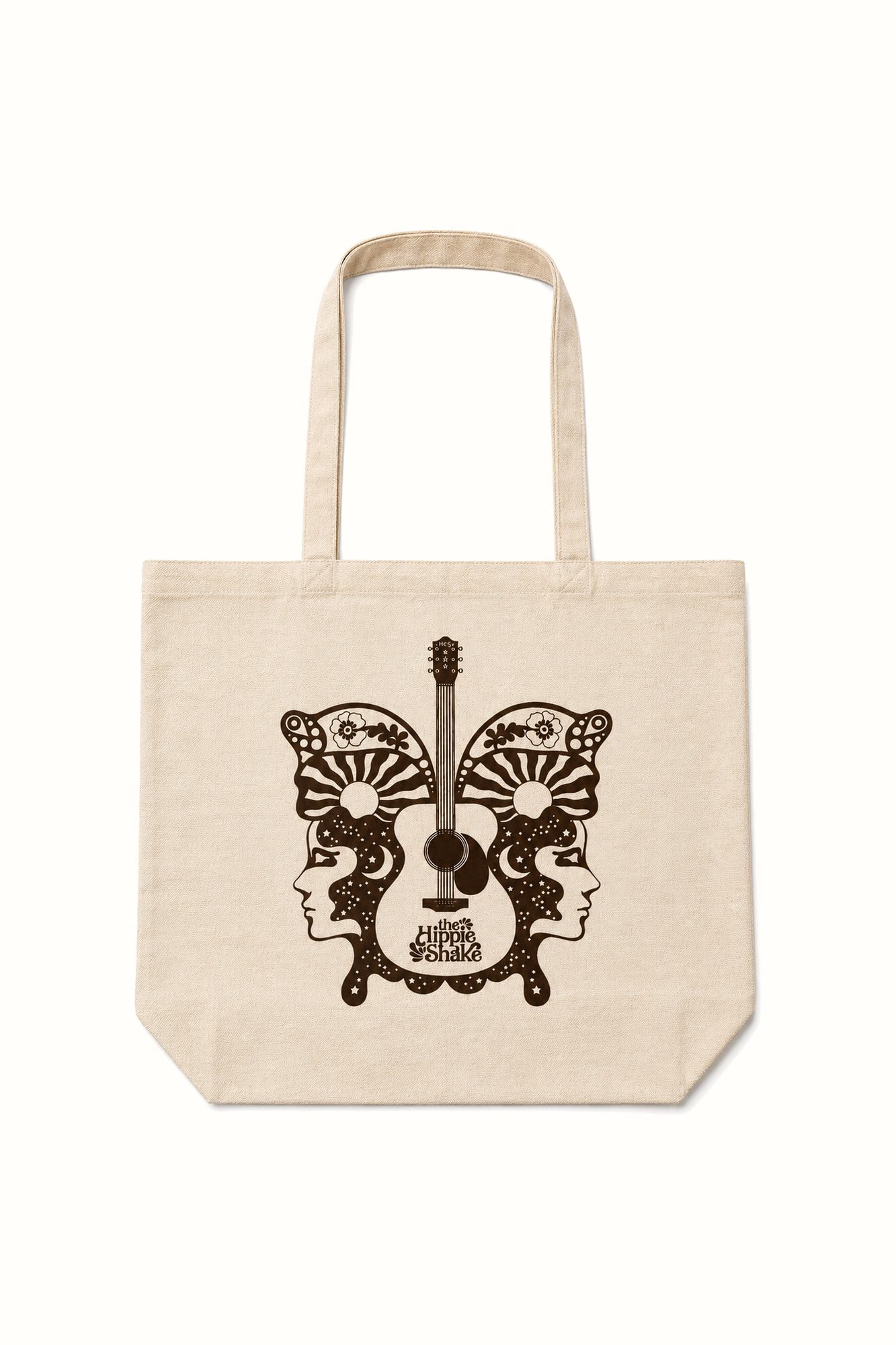 A natural canvas tote bag with a dark brown graphic print of a guitar and butterfly wings featuring stylized faces and sunburst patterns, shown against a plain white background.
