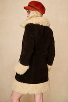 Model wears dark brown embroidered Penny Lane coat in faux suede with faux fur trim. A 70s-inspired statement coat made for bold, vintage boho styling by The Hippie Shake - back view