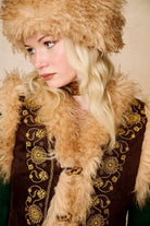 Model wears brown embroidered Penny Lane vest in faux suede with faux fur trim. A 70s-inspired boho layering piece made for vintage and festival styling by The Hippie Shake - close up view