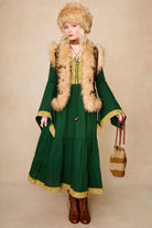 Model wears brown embroidered Penny Lane vest in faux suede with faux fur trim. A 70s-inspired boho layering piece made for vintage and festival styling by The Hippie Shake - standing front view