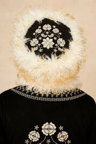 Model wears cream faux fur hat with vintage detailing and embroidered finish. A 70s-inspired boho winter hat made for statement styling by The Hippie Shake - back view