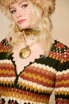 Model wears striped crochet midi dress hand crocheted in cotton with 70s-inspired detailing by The Hippie Shake. Front close up view