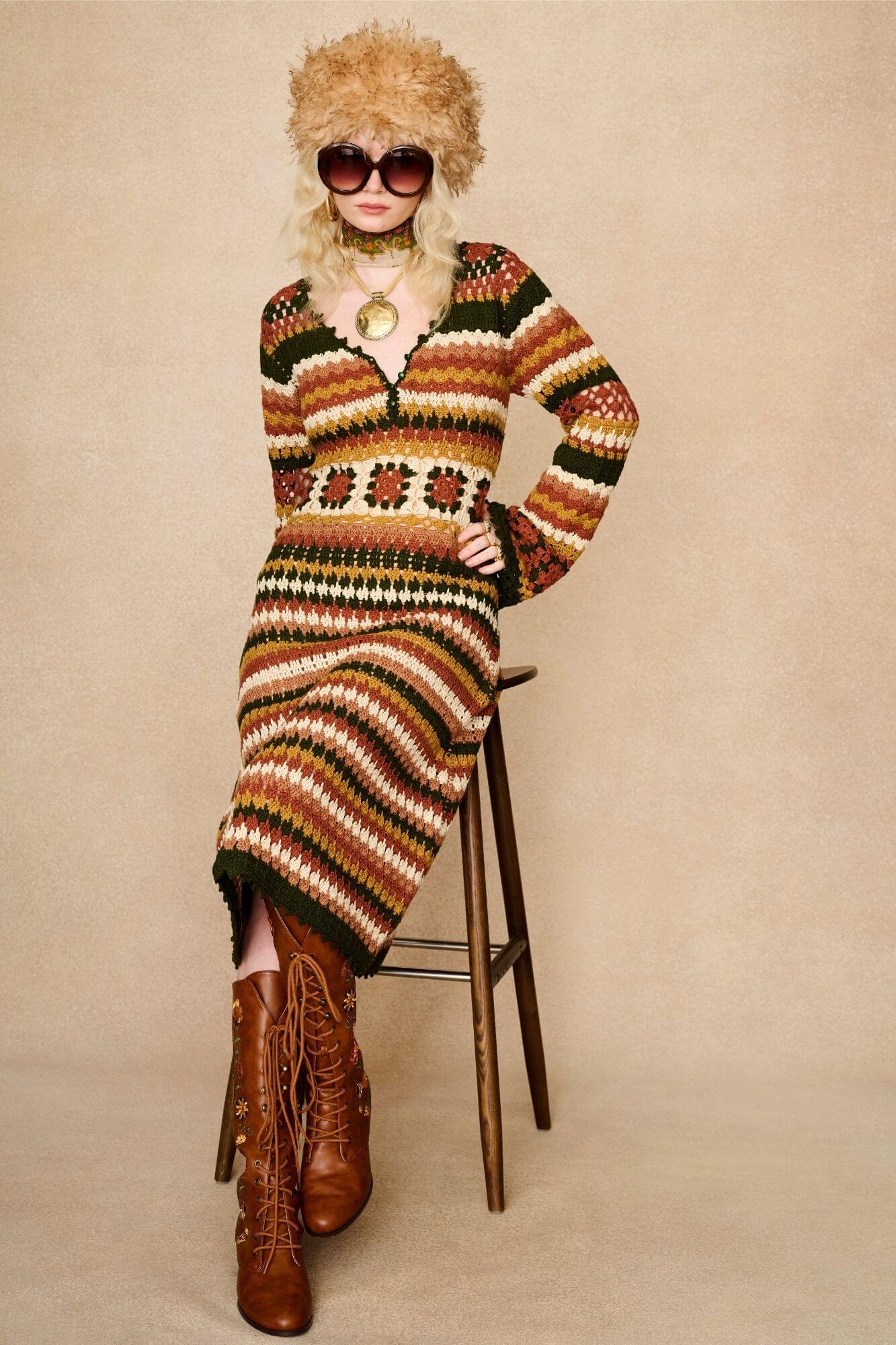 Model seated wears striped crochet midi dress hand crocheted in cotton with 70s-inspired detailing by The Hippie Shake