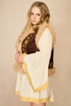 Model wears brown embroidered Penny Lane vest in faux suede with faux fur trim. A 70s-inspired boho layering piece made for vintage and festival styling by The Hippie Shake - side view paired with cream dress