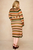 Model wears striped crochet midi dress hand crocheted in cotton with 70s-inspired detailing by The Hippie Shake. Back view