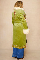 Model wears green embroidered Penny Lane coat in cotton corduroy with faux fur trim. A 70s-inspired statement coat made for bohemian, vintage styling by The Hippie Shake - back view