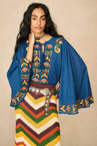 Model wearing 70s blue long sleeve top by The Hippie Shake, front view