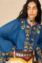 Model wearing 70s blue long sleeve top by The Hippie Shake, close up