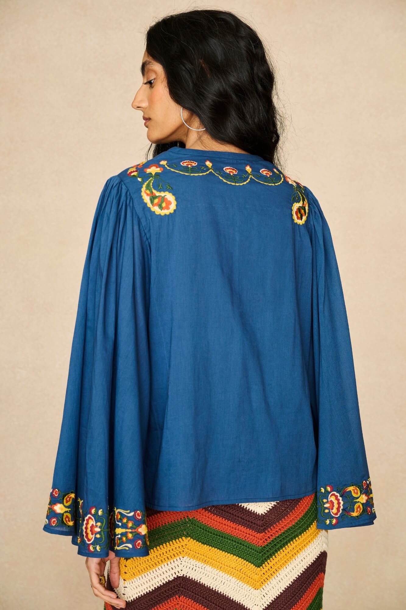 Model wearing 70s blue long sleeve top by The Hippie Shake, back view