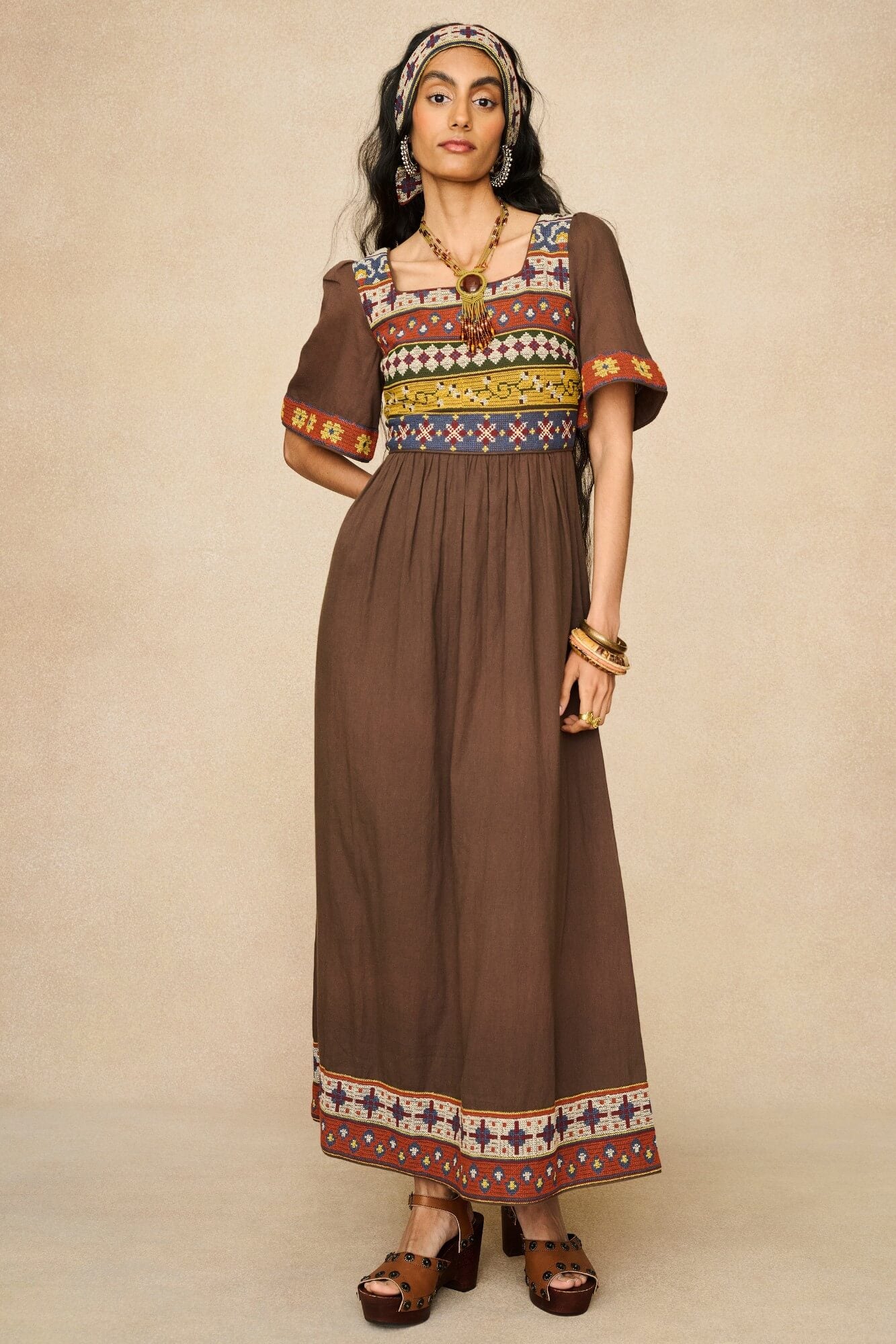 Model wearing brown embroidered maxi dress by The Hippie Shake, front view