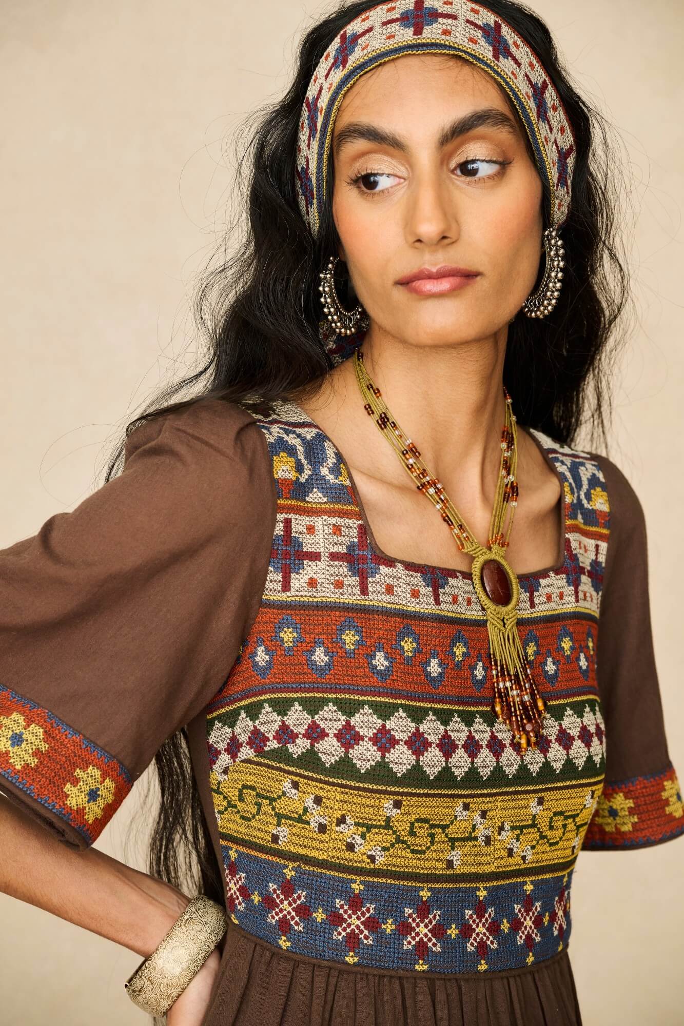 Model wearing brown embroidered maxi dress by The Hippie Shake, close up